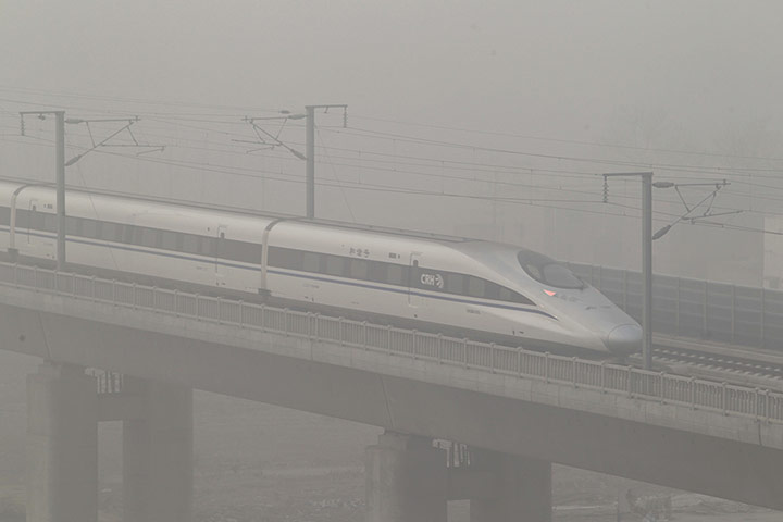 Air Pollution in China: A high-speed railway runs amid heavy fog in Xuchang, China's Henan Province