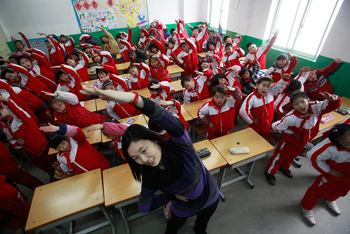 Air Pollution in China: body exercise during class break in a classroom on a foggy day in Jinan