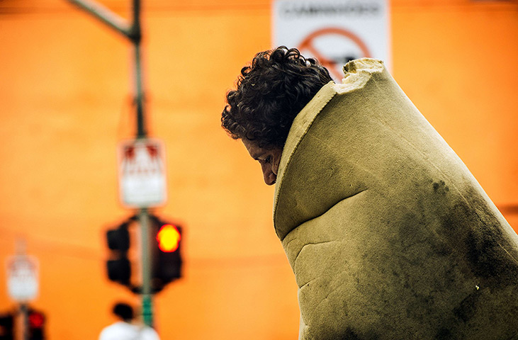 24 hours: Sao Paulo, Brazil: A homeless man wrapped up in a foam mattress