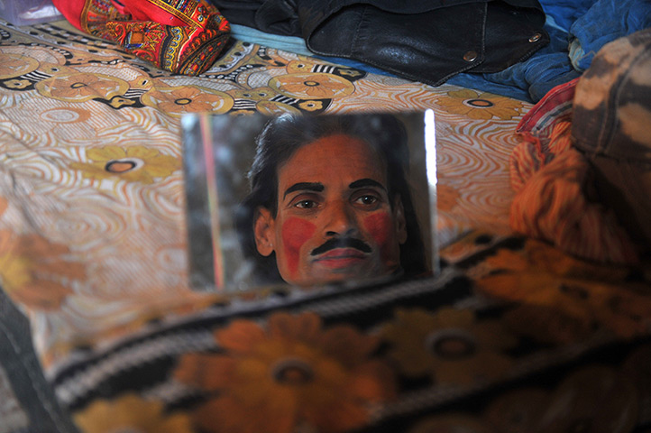 24 hours: Siliguri, India: A clown applies makeup in a tent