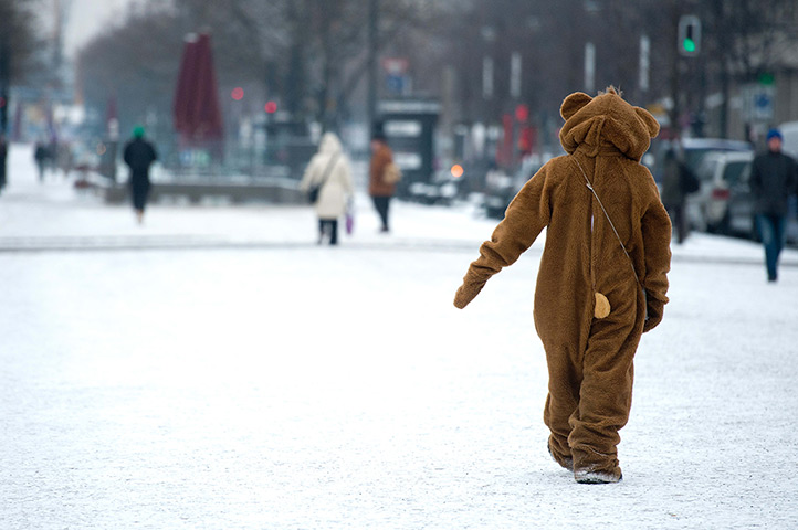 24 hours: Berlin, Germany: A man wearing a bear costume walks through the snow