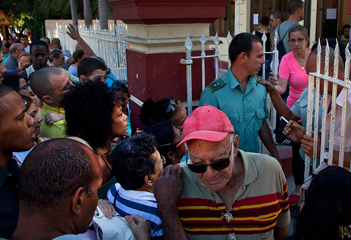 24 hours: Havana, Cuba: People line up at a migration office