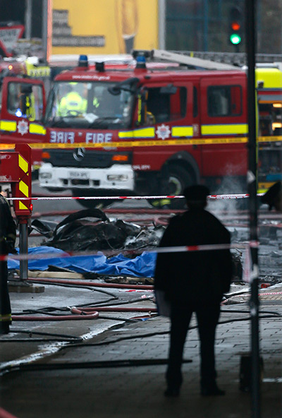 Helicopter crash: Smoke rises from debris as police and emergency services