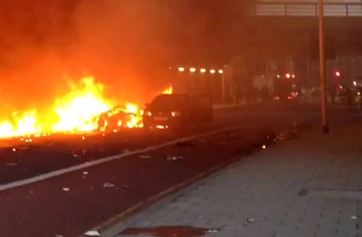 Helicopter crash: A car can be seen burning a the street after the crash