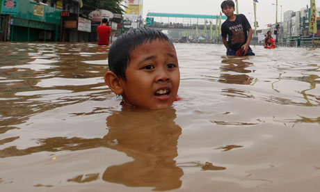 A boy in a flooded road in Jakarta