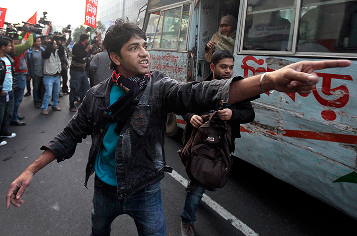 24 hours: Dhaka, Bangladesh: A party activist shouts a warning for a bus to stop