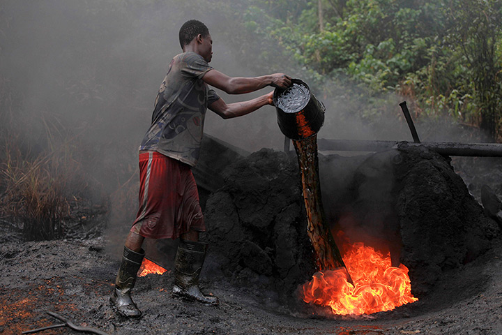 from the agencies: Illegal oil refinery in Nigeria by Akintunde Akinleye