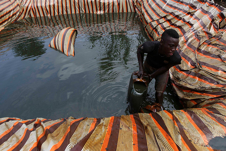 from the agencies: Illegal oil refinery in Nigeria by Akintunde Akinleye