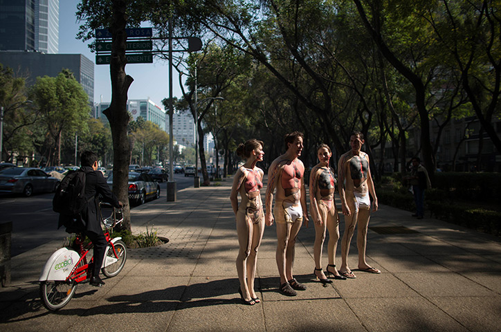 24 hours in pictures: Activists wearing body paint that illustrates their organs, Mexico