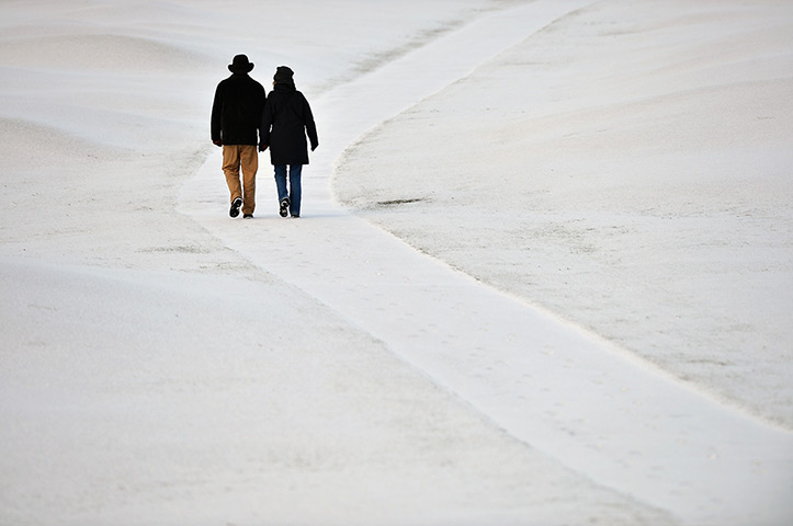 uk weather:  People walk on St Andrews Golf Course in Fife