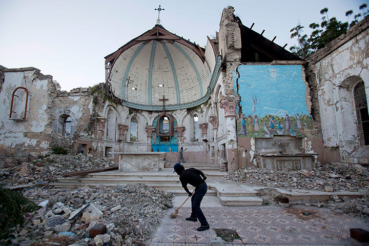 20 Photos: A man sweeps in the earthquake-damaged Santa Ana church in Port-au-Prince
