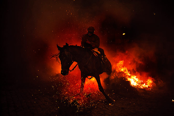 20 Photos: A man rides a horse through a bonfire in San Bartolome de Pinares, Spain