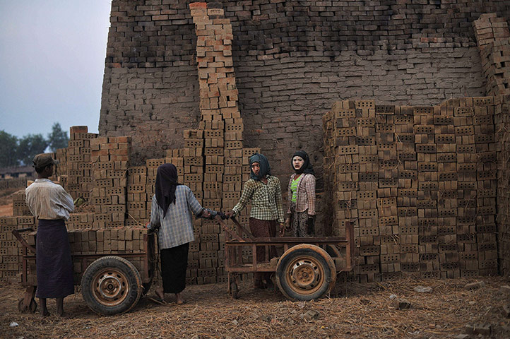 20 Photos: Workers stand by piles of bricks at a factory on the outskirts of Yangon