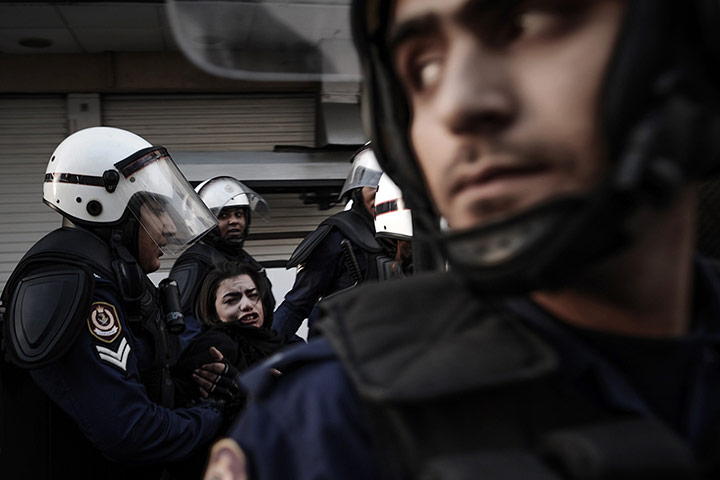 20 Photos: A protestor is arrested by riot policemen during a demonstration in Manama