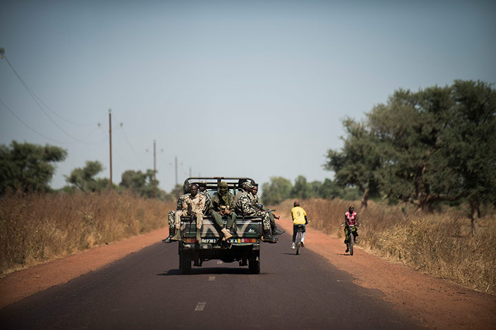 20 Photos: Malian soldiers sit in a pick up on their way to Niono