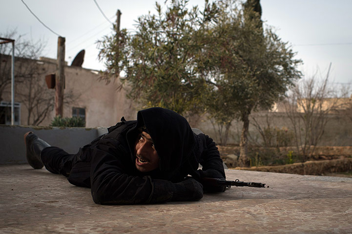 24 Hours: A rebel fighter ducks for cover from government jet fighters in Aleppo, Syria