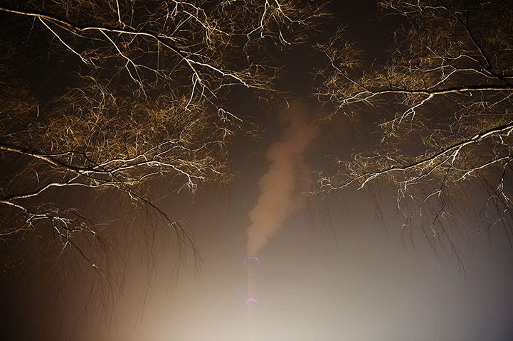 24 Hours: A power station chimney in Beijing, China, as severe pollution strikes the city's inhabitants
