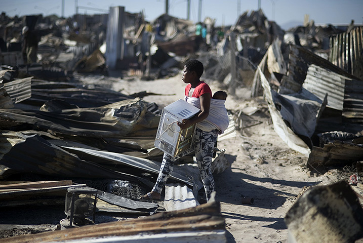 24 hours in pictures: A young woman salvages a microwave from