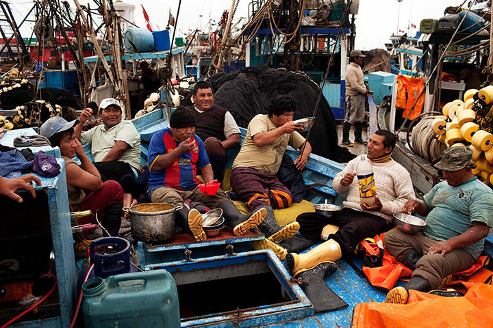 FTA: Rodrigo Abd: Fishermen eat lunch in the bow of a fishing boat