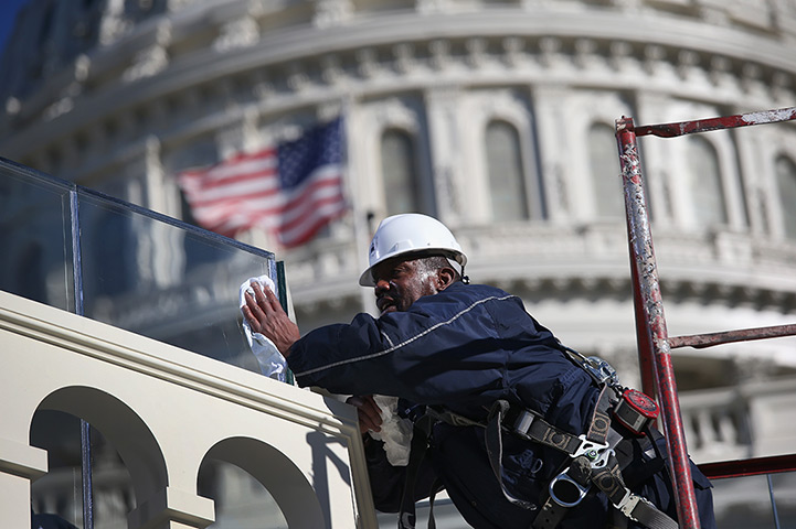 24 hours: Washington, DC , US:  A worker cleans bulletproof glass 