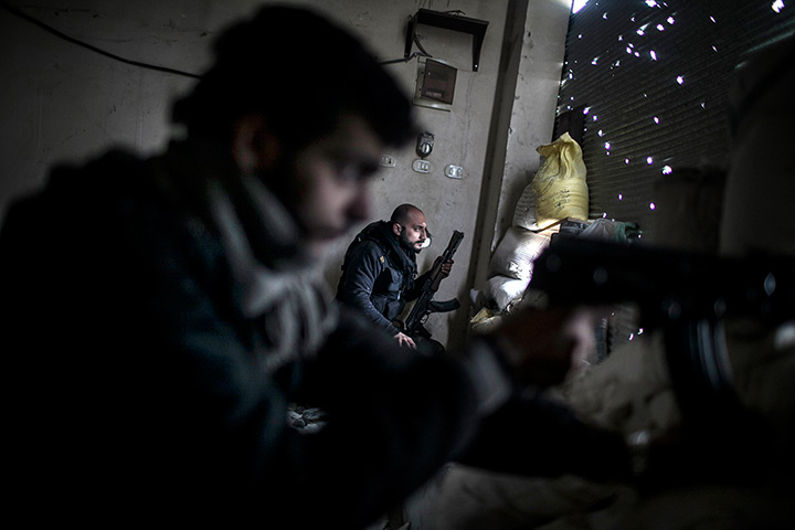 24 hours: Aleppo, Syria: Free Syrian Army fighters hold their weapons during clashes