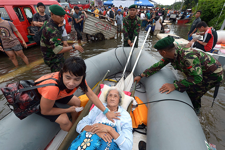 24 hours: Jakarta, Indonesia: An ailing 87-year-old woman lies in a boat