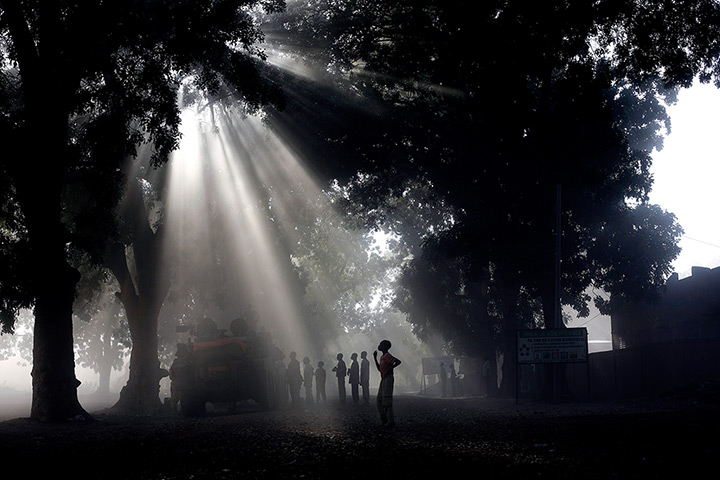 24 hours: Niono, Mali: Bystanders stand by a French APC