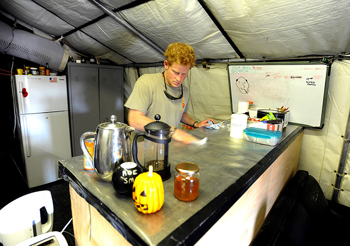 Prince Harry Afghanistan: Prince Harry cleans the kitchen work surface
