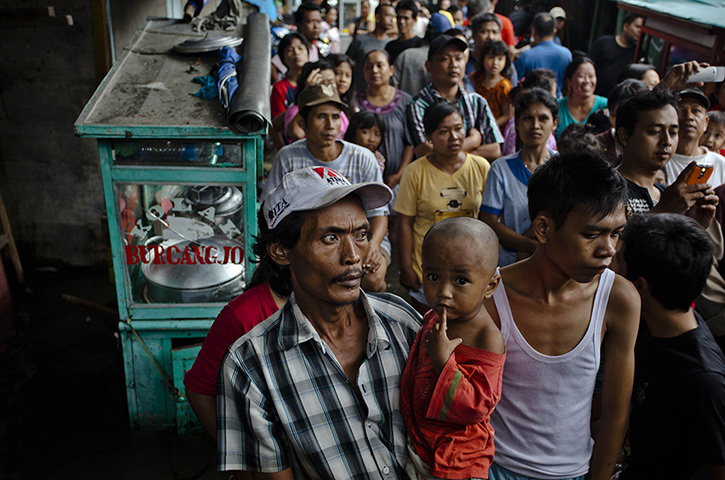 FTA: Ulet Ifansasti: People queue for food aid in North Jakarta