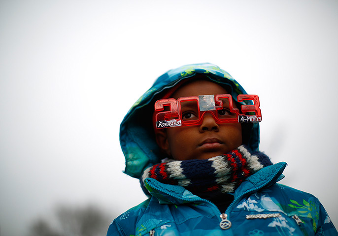 24 hours in pictures:  boy listens to the inauguration ceremonies for President Barack Obama