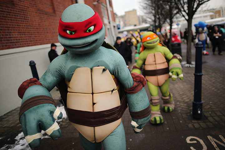 Toy Fair: Life size Teenage Mutant Ninja Turtles cartoon characters are led outside