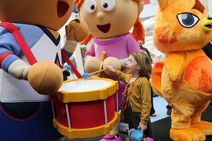 Toy Fair: Betsy McCredie, 4, from Glasgow interacts with life size cartoon characters