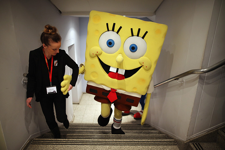 Toy Fair:  A Sponge Bob Square Pants character is helped up a flight of stairs