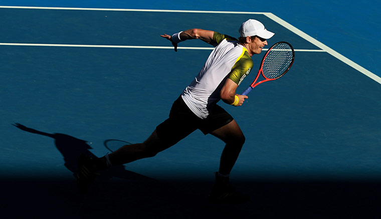 Andy Murray in action races towards the baseline