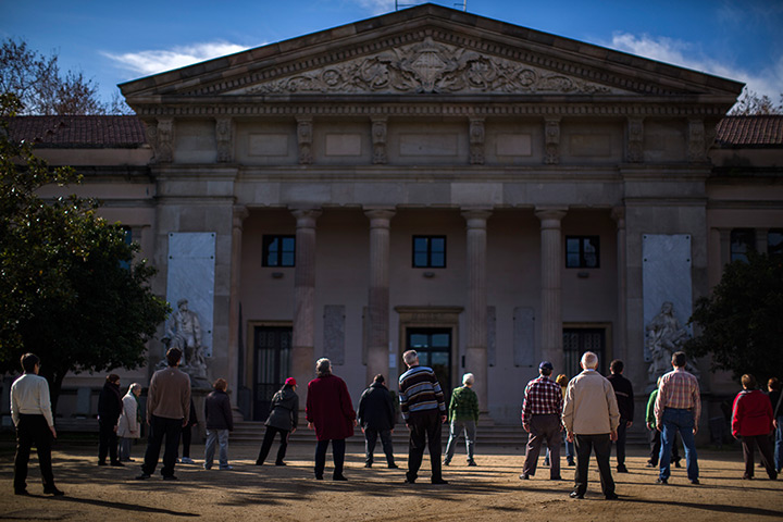 24 hours: Barcelona, Spain: men and women exercise in a public park 