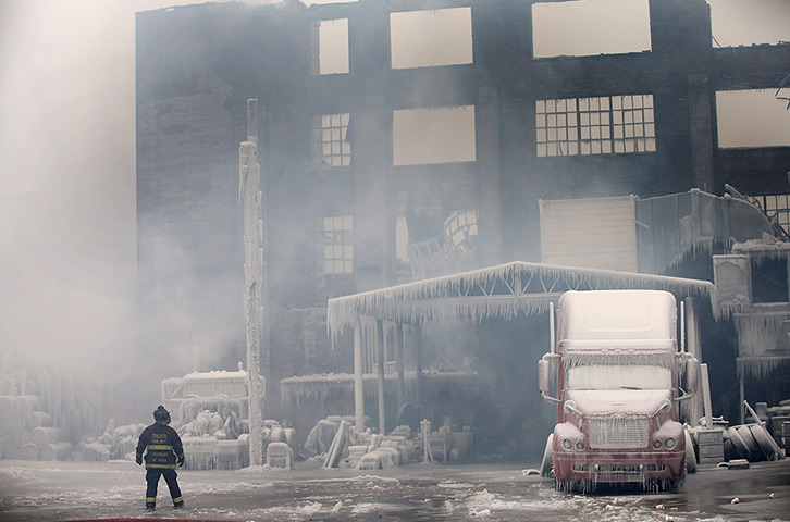 24 hours: Chicago, Illinois, US: Firefighters work to extinguish a massive blaze