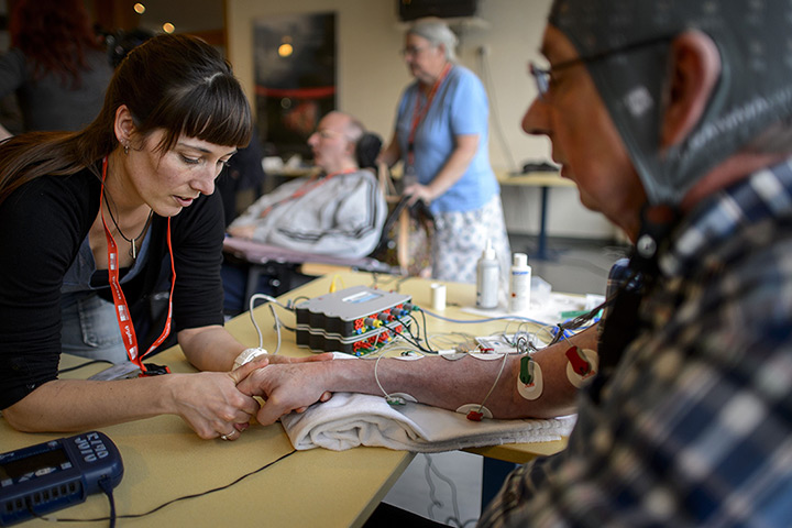 24 hours: Sion, Switzerland: A physiotherapist holds the hand of a patient