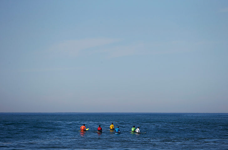 A lighter look: A group of contestants wait for a wave