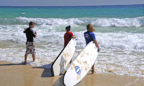 Two girls take their first surfing lesson Rainbow Beach, Cooloola, Queensland, Australia