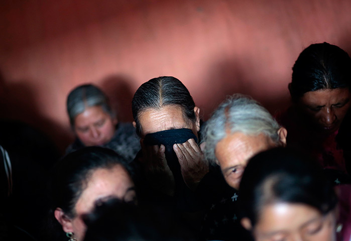24 hours in pictures: Relatives cry during the arrival of the skeleton of Roberto Enrique Cac Suc