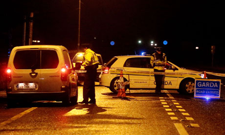 Irish police man a checkpoint near the scene where a detective was shot dead in Dundalk