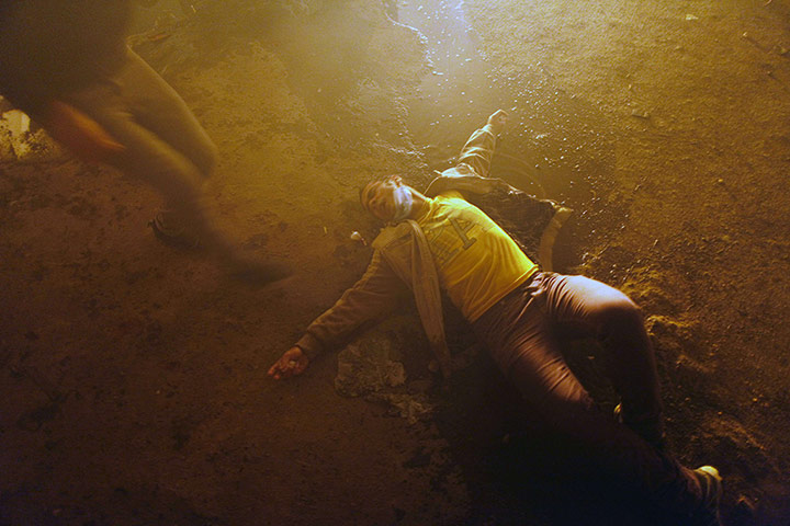 20 Photos: An Egyptian protester falls down in Tahrir Square