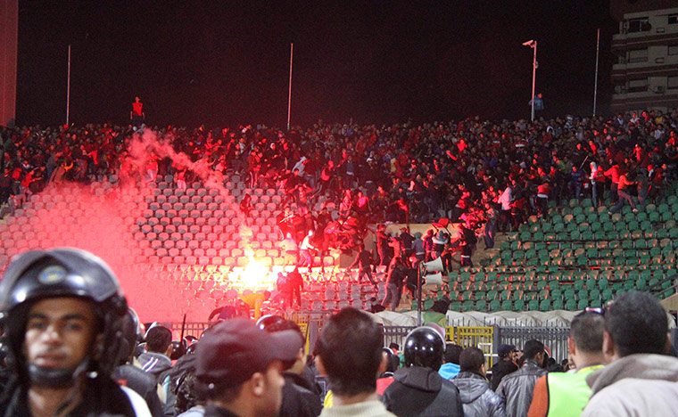 Said: Soccer fans flee from a fire at Port Said Stadium