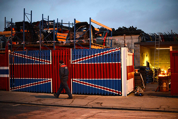 24 Hours: A man walks past a car scrap yard in east London