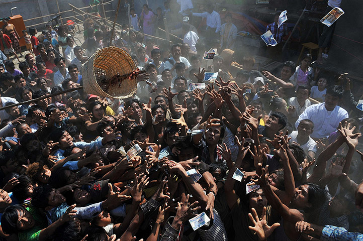 24 Hours: People try to catch money given away in Yangon, Myanmar