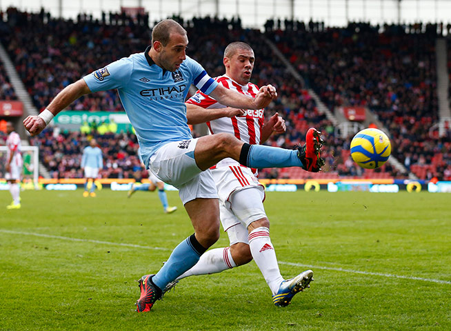 fa cup round-up: Stoke City's Walters challenges Manchester City's Zabaleta 