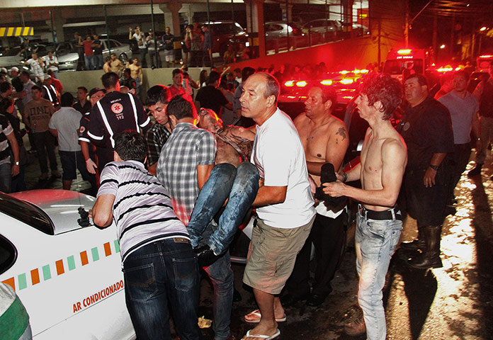 Rio nightclub: A victim of the fire is carried away from the Kiss nightclub