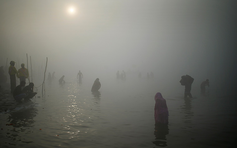 24 hours: Hindu pilgrims take a dip at the Sangam during the Maha Kumbh festival 