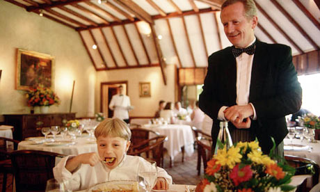 A child eating in an expensive restaurant