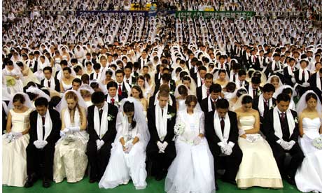 About 4,600 couples, some from foreign countries, pray during a mass wedding ceremony in Korea
